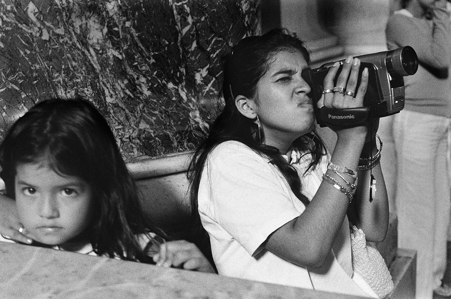 Kobieta z kamerą w bazylice św. Piotra w Watykanie. Fotografia czarno-biała. Negatyw